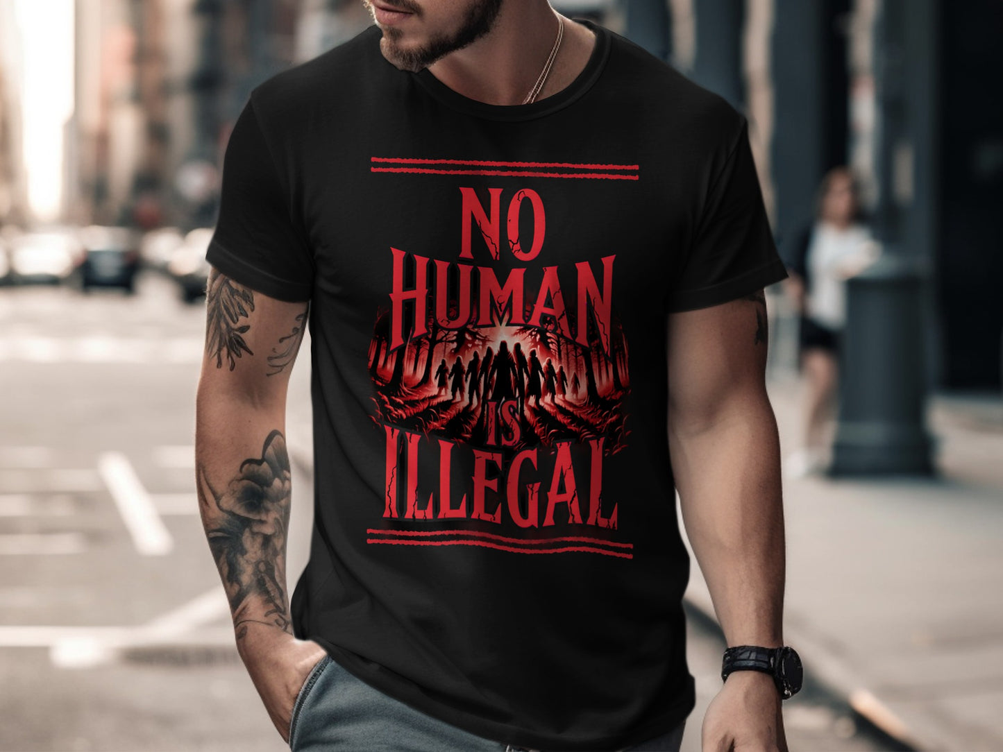 Black t-shirt with red text and graphic "No Human Is Illegal"