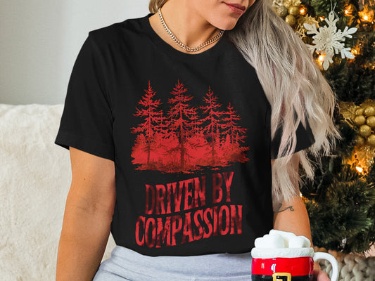 Black t-shirt with red forest silhouette and "DRIVEN BY COMPASSION" text.