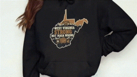 A person wearing a black hoodie with a graphic design on the back.