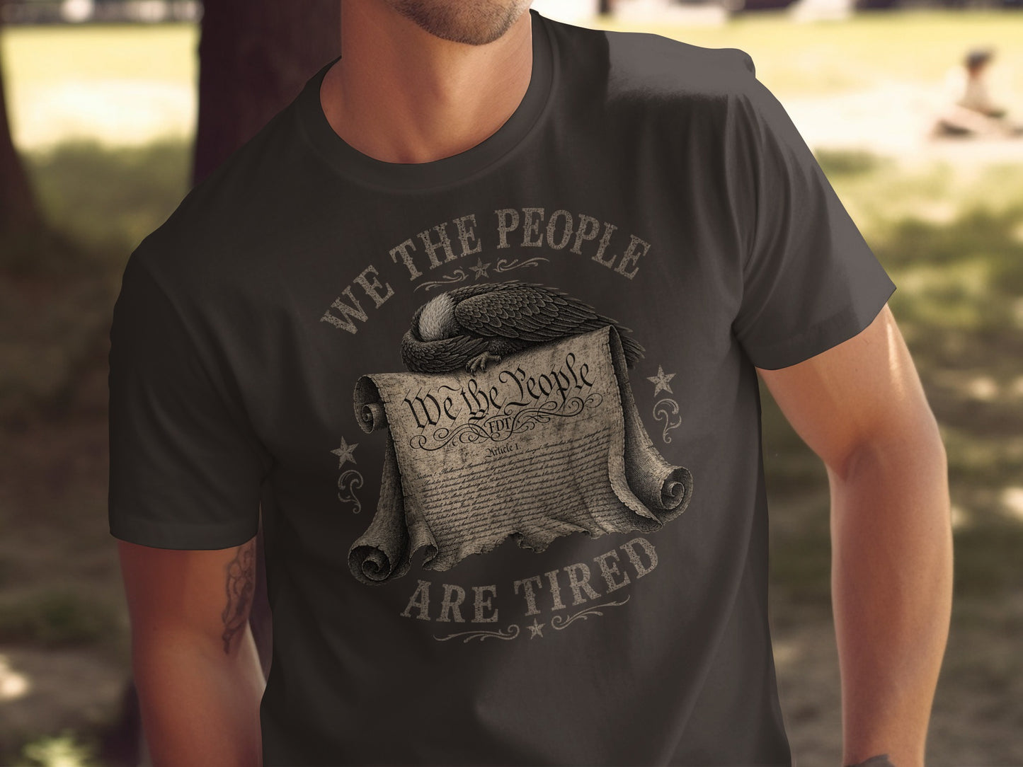 T-shirt with "WE THE PEOPLE ARE TIRED" and an eagle over the Constitution.