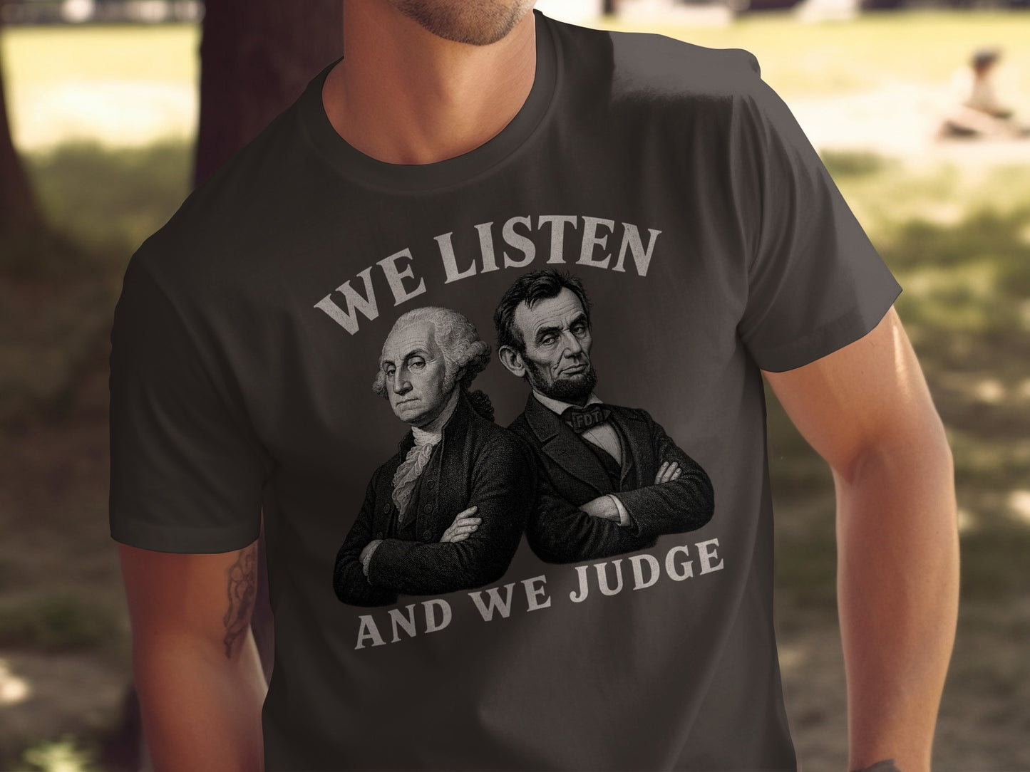 T-shirt with portraits of Washington and Lincoln, text "WE LISTEN AND WE JUDGE".
