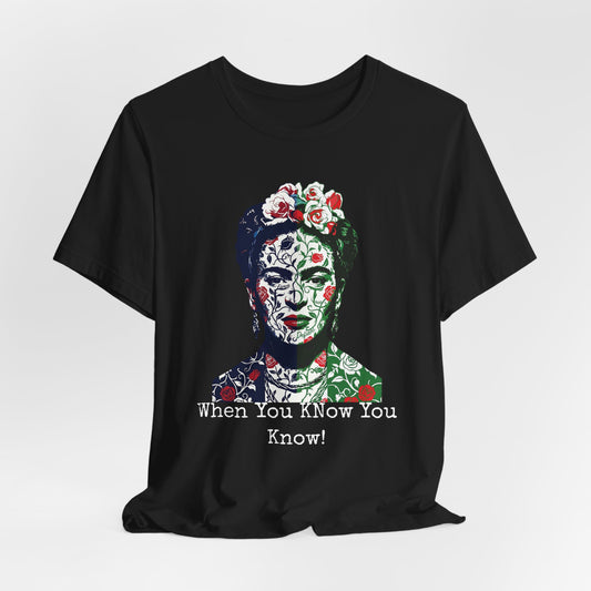 Black t-shirt with Frida Kahlo's face adorned with floral patterns and text.