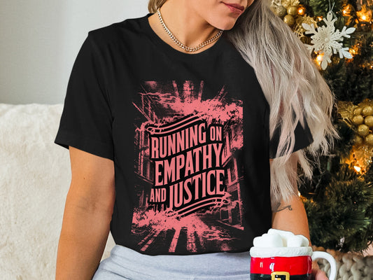 Black t-shirt with "Running on Empathy and Justice" text and pink distressed graphic.