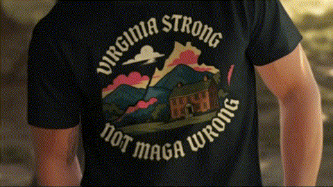 a person wearing a black t-shirt with a graphic design featuring a house and mountains.