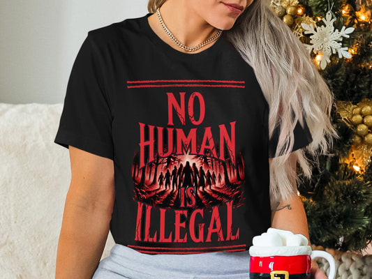 Black t-shirt with "NO HUMAN IS ILLEGAL" text and silhouette figures.
