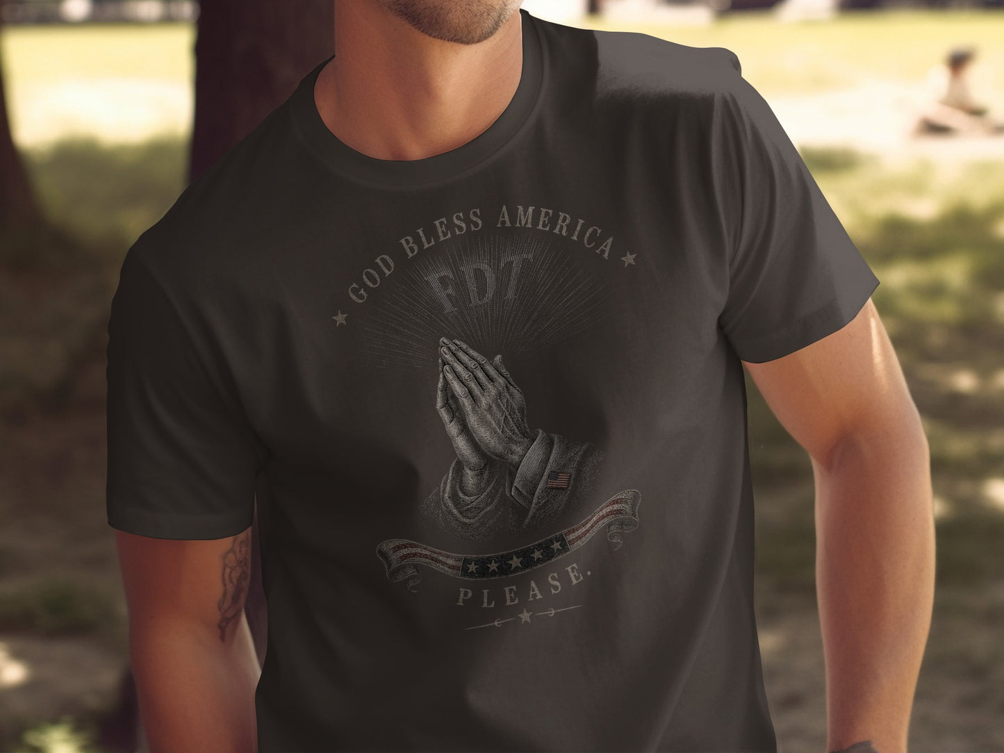 Dark t-shirt with praying hands, "GOD BLESS AMERICA", "FDT", and American flag graphic.