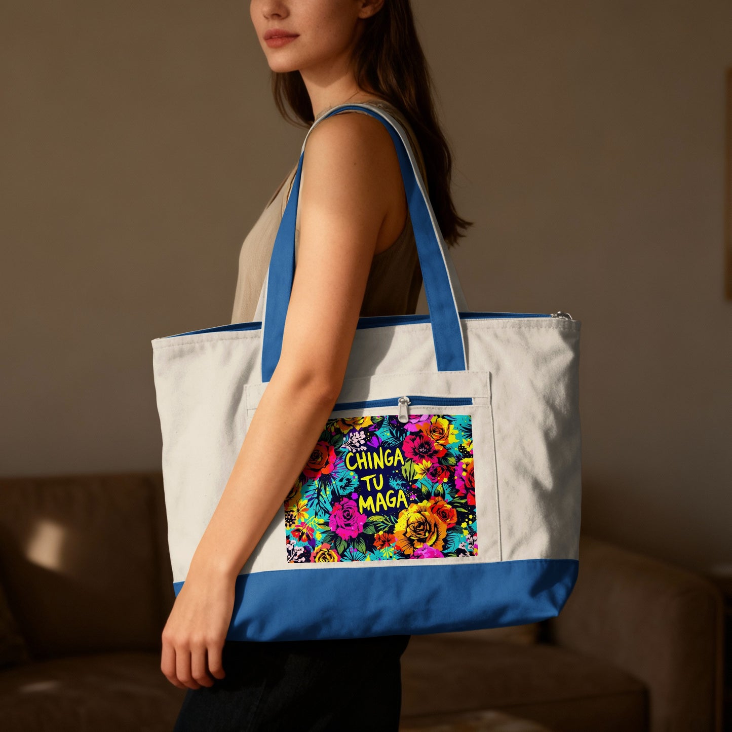 Woman holding a white and blue canvas tote bag with a vibrant floral design and text.