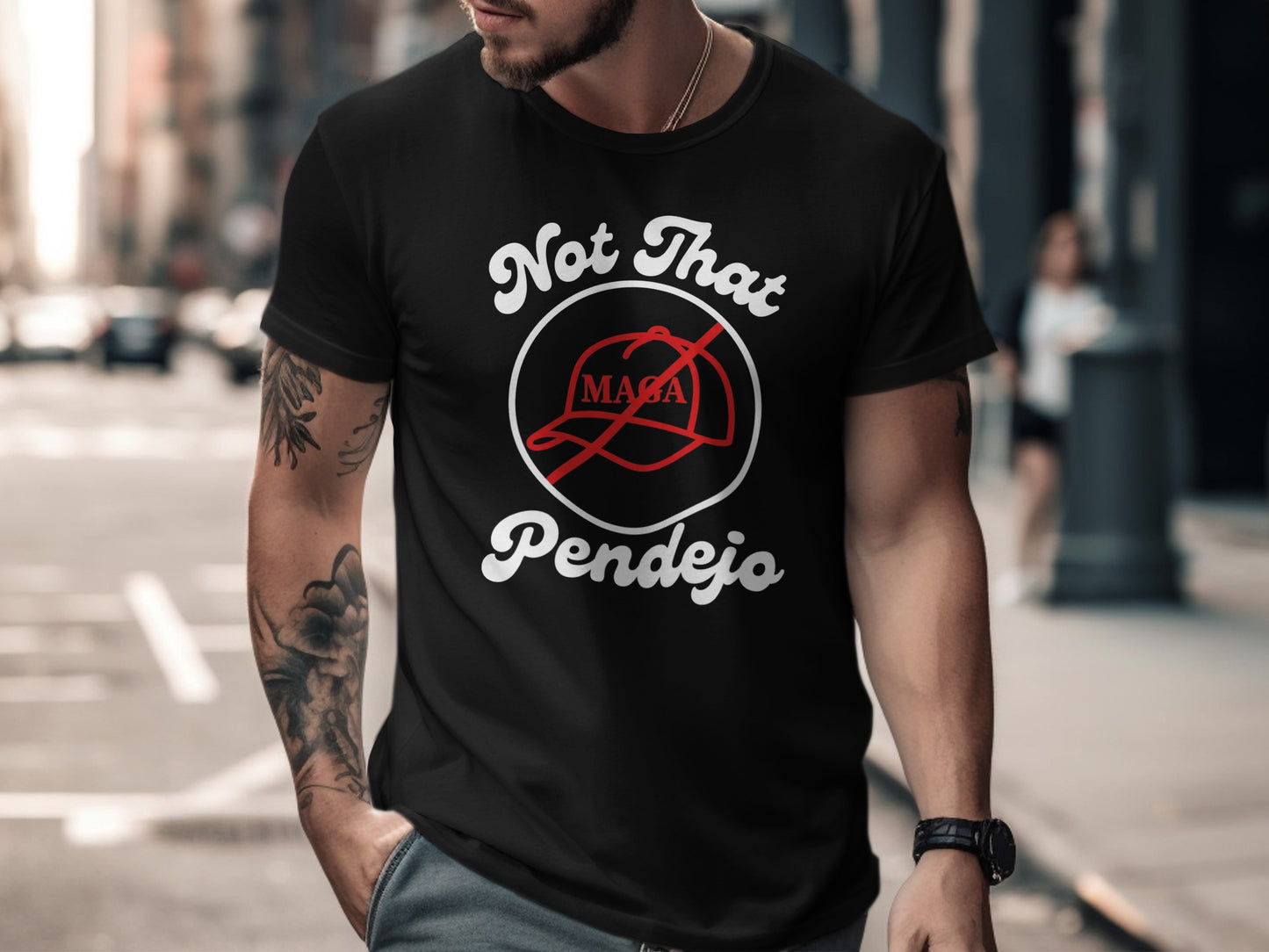 Black t-shirt with "Not That Pendejo" text and a red baseball cap graphic.