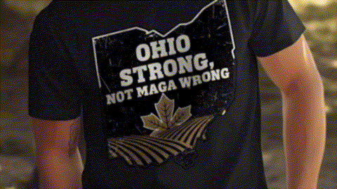 A black t-shirt with a graphic design on the back, featuring a graphic of a state with the text "OHIO STRONG, NOT MAGA WRONG" printed on it.