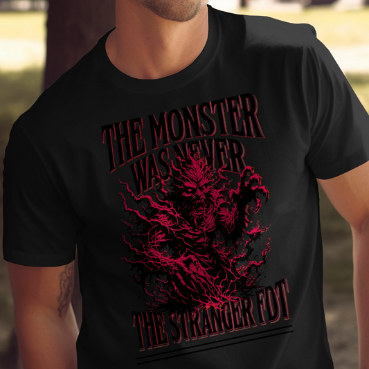 Black t-shirt with red graphic of a monster and text "THE MONSTER WAS NEVER THE STRANGER FOT".