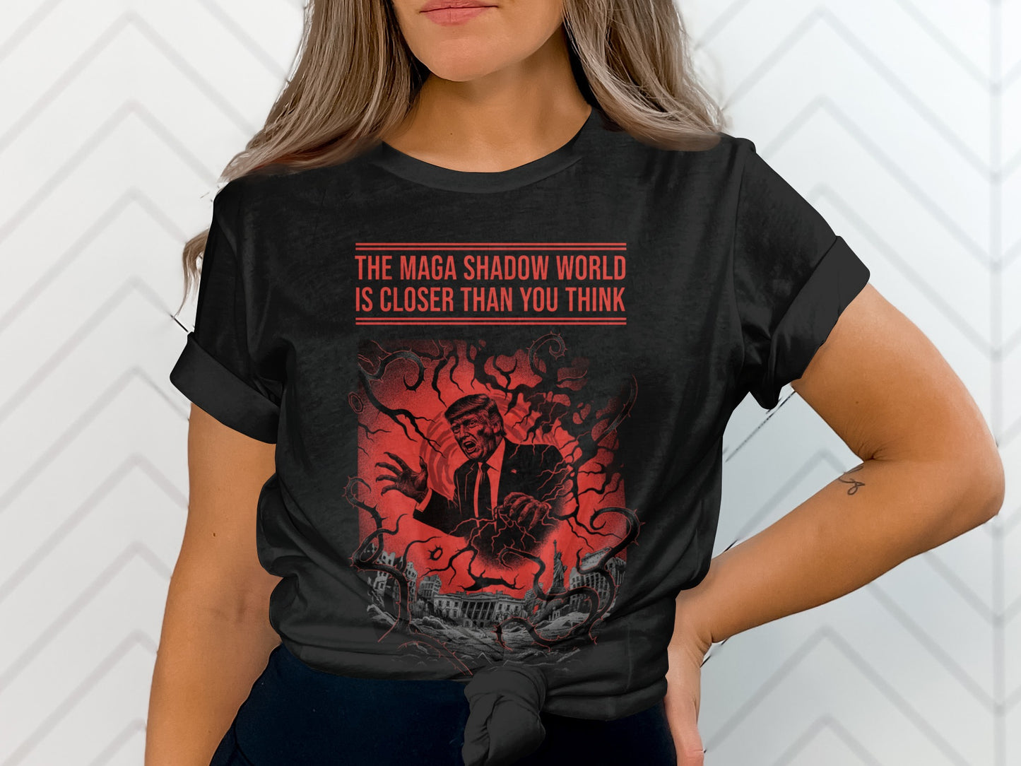 Black t-shirt with red text: "THE MAGA SHADOW WORLD IS CLOSER THAN YOU THINK."