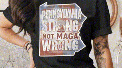 A person wearing a black t-shirt with a graphic design that says "Pennsylvania Strong Not MAGA Wrong".