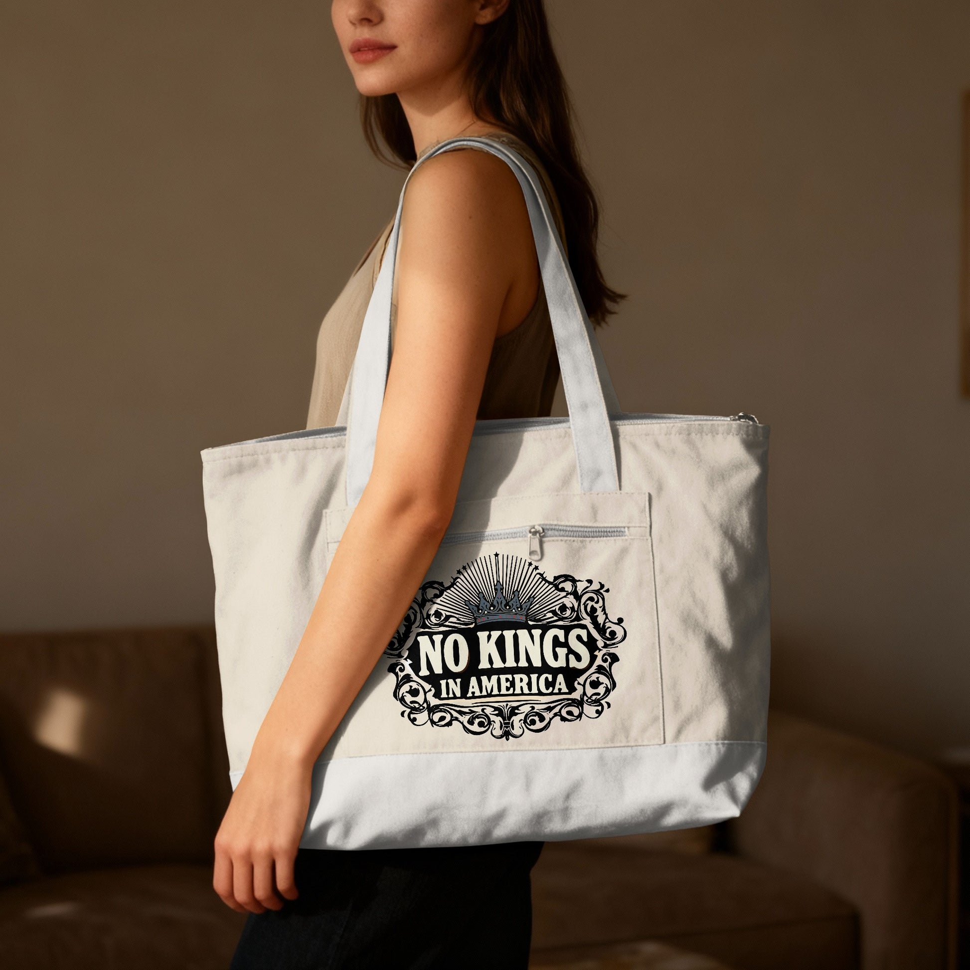 Light colored tote bag with "No Kings in America" text and crown graphic.