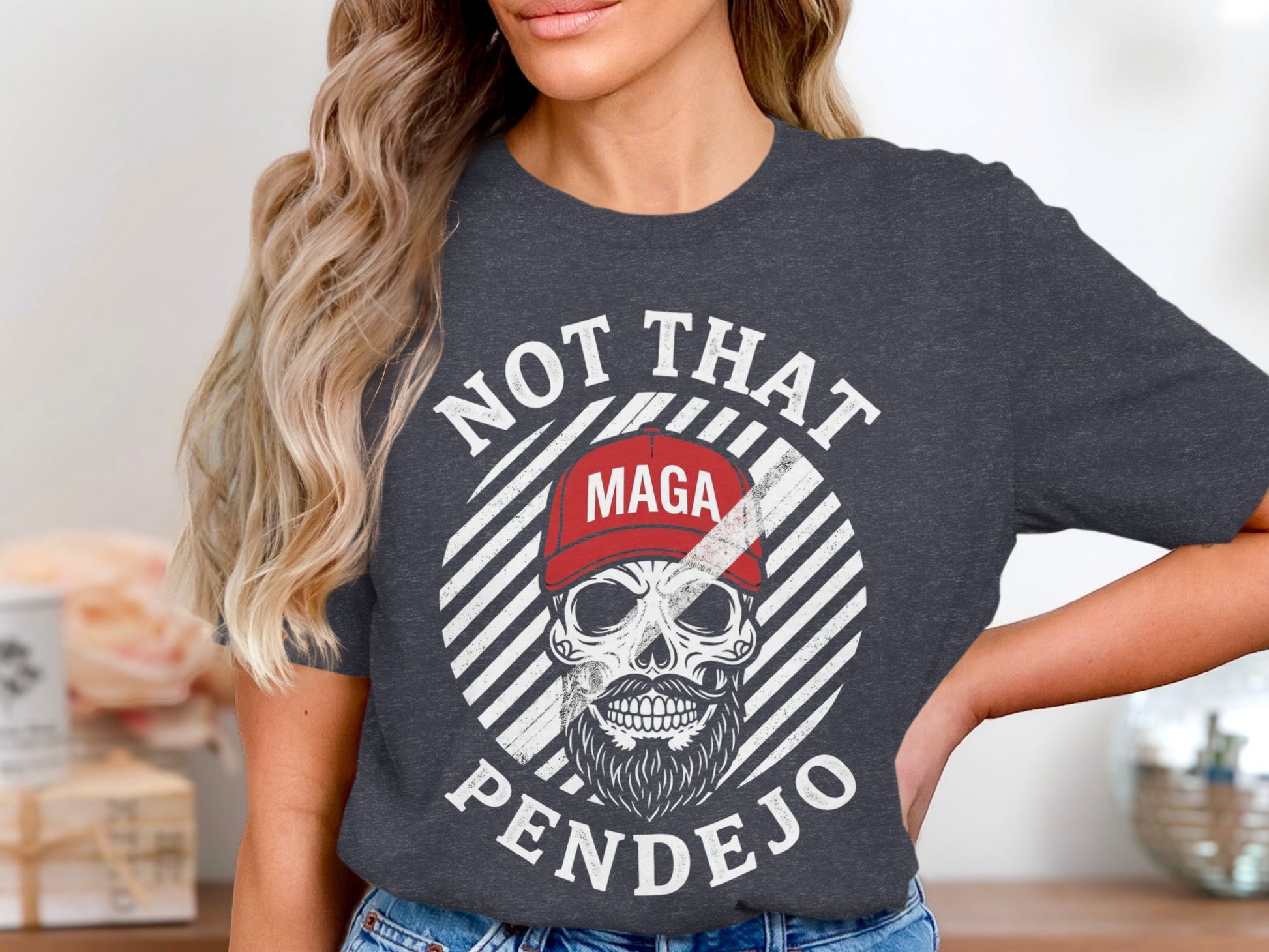 Dark grey t-shirt with skull graphic, red MAGA hat, and text NOT THAT PENDEJO.