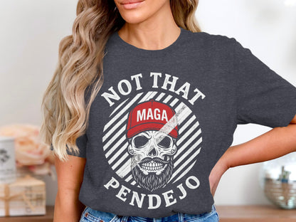 Dark grey t-shirt with skull graphic, red MAGA hat, and text NOT THAT PENDEJO.
