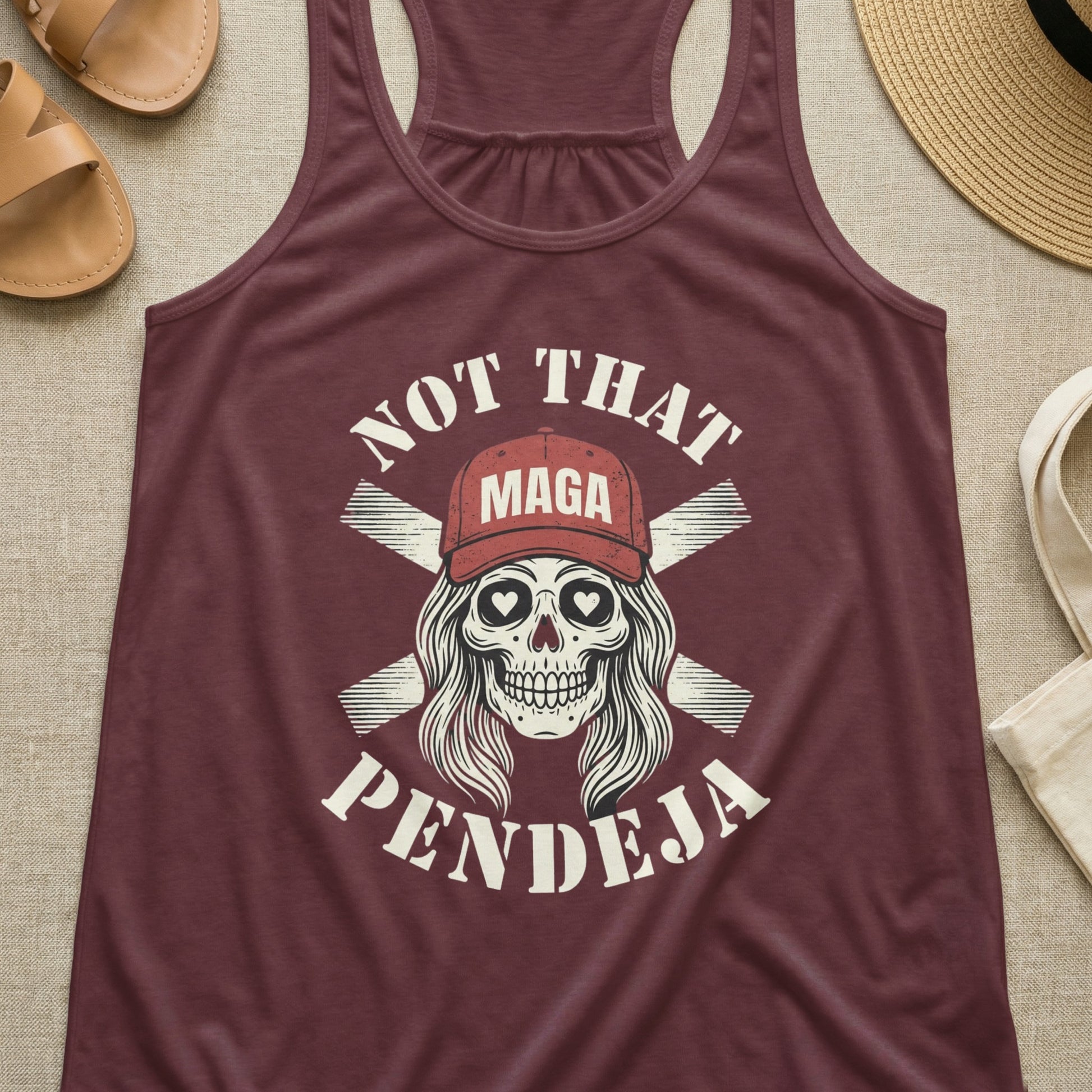 Maroon tank top with skull graphic and "Not That Pendeja" text.