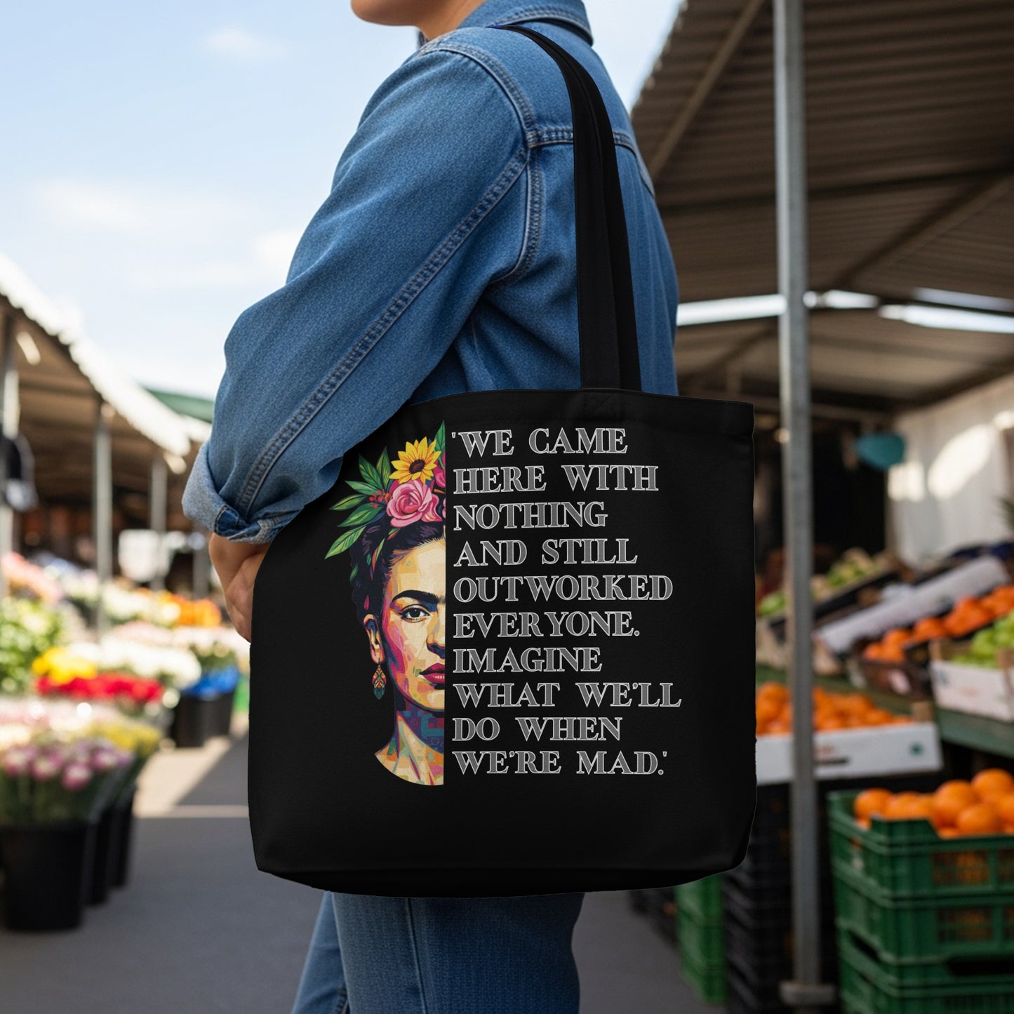 Black tote bag with Frida Kahlo image and empowering quote.