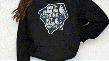 A person wearing a black hoodie with a graphic design on it.