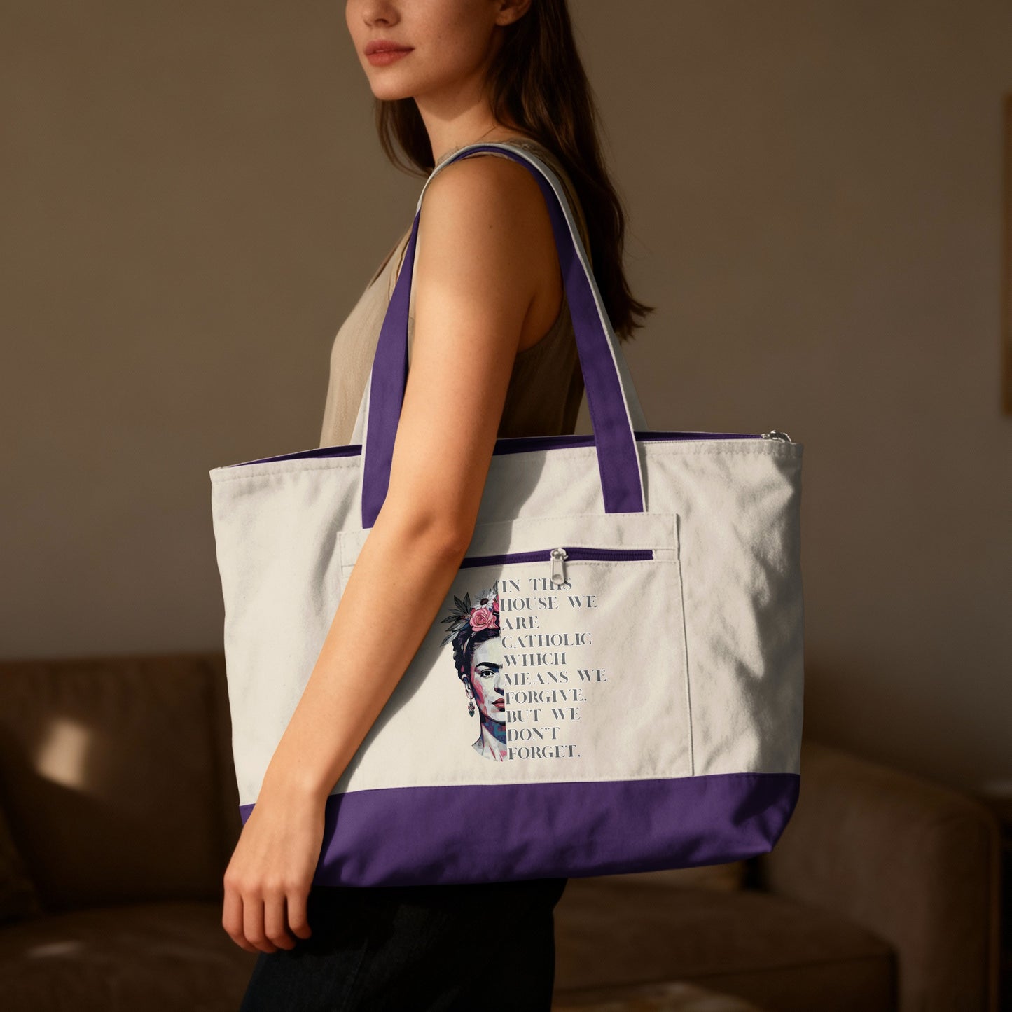 White canvas tote bag with purple trim and Frida Kahlo graphic with text.