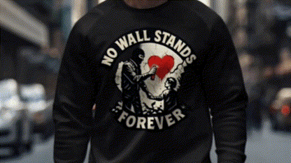 A person wearing a black sweatshirt with a graphic design on it.