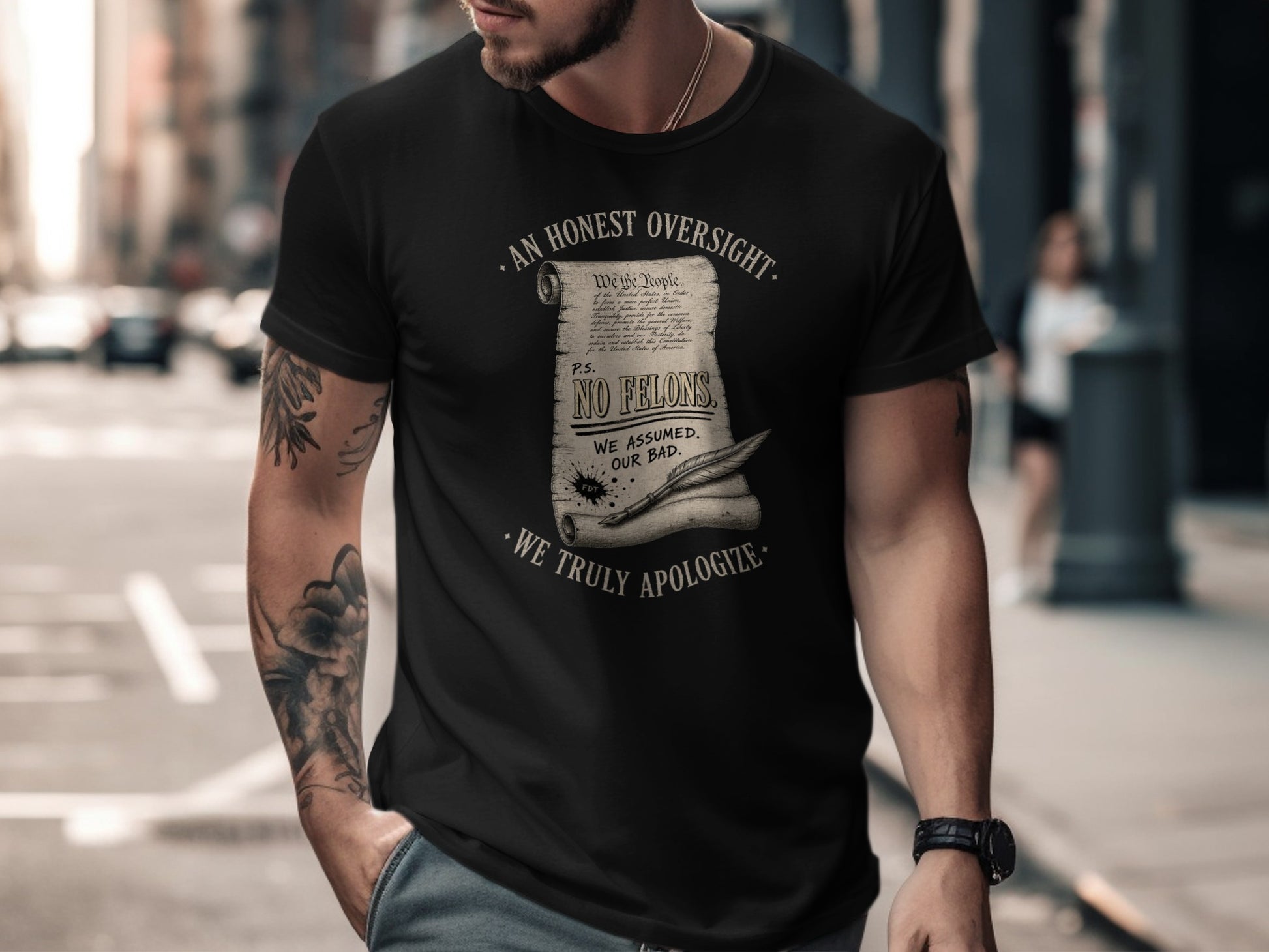 Black t-shirt with "We the People" text and "NO FELONS. WE ASSUMED. OUR BAD."