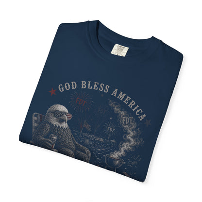Eagle wearing sunglasses relaxing by grill with "God Bless America" text.