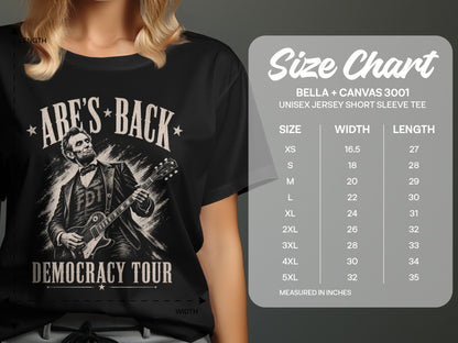T-shirt with Abraham Lincoln playing guitar and "Abe's Back Democracy Tour" text.