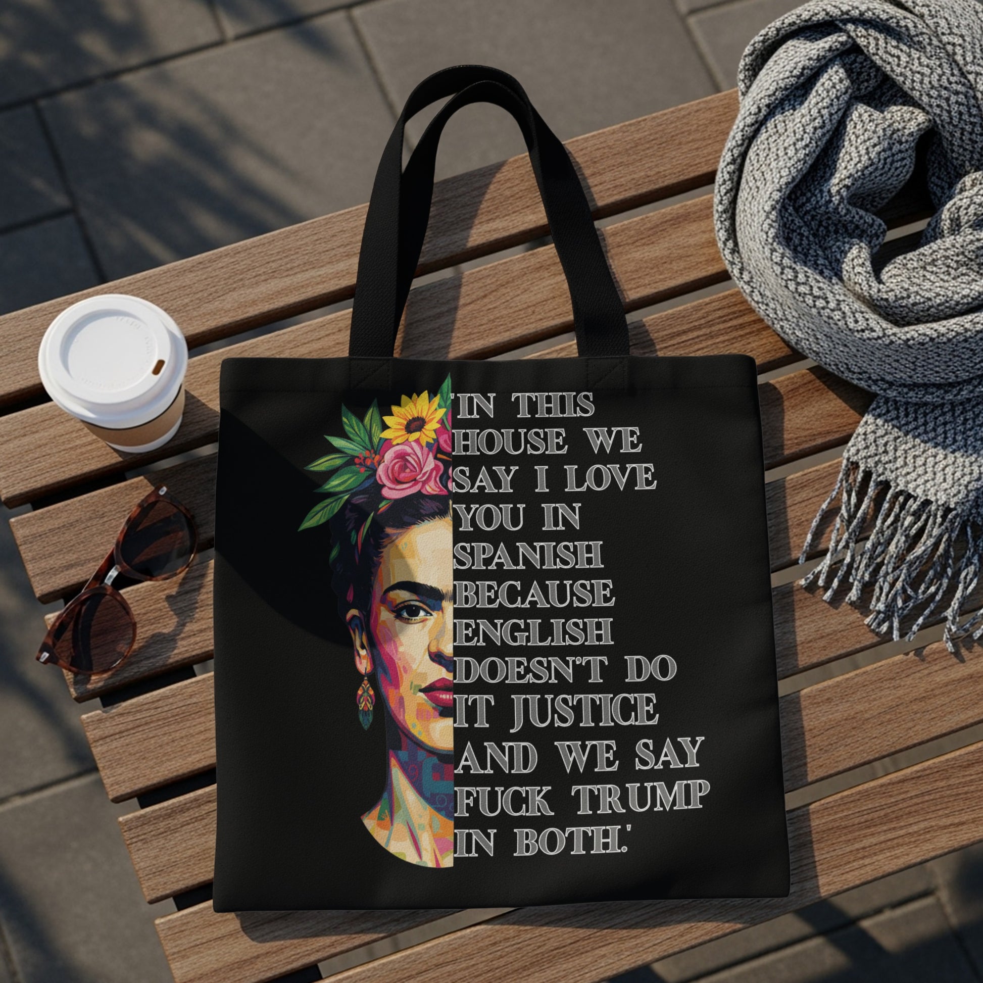 Black tote bag with Frida Kahlo artwork and protest slogan.