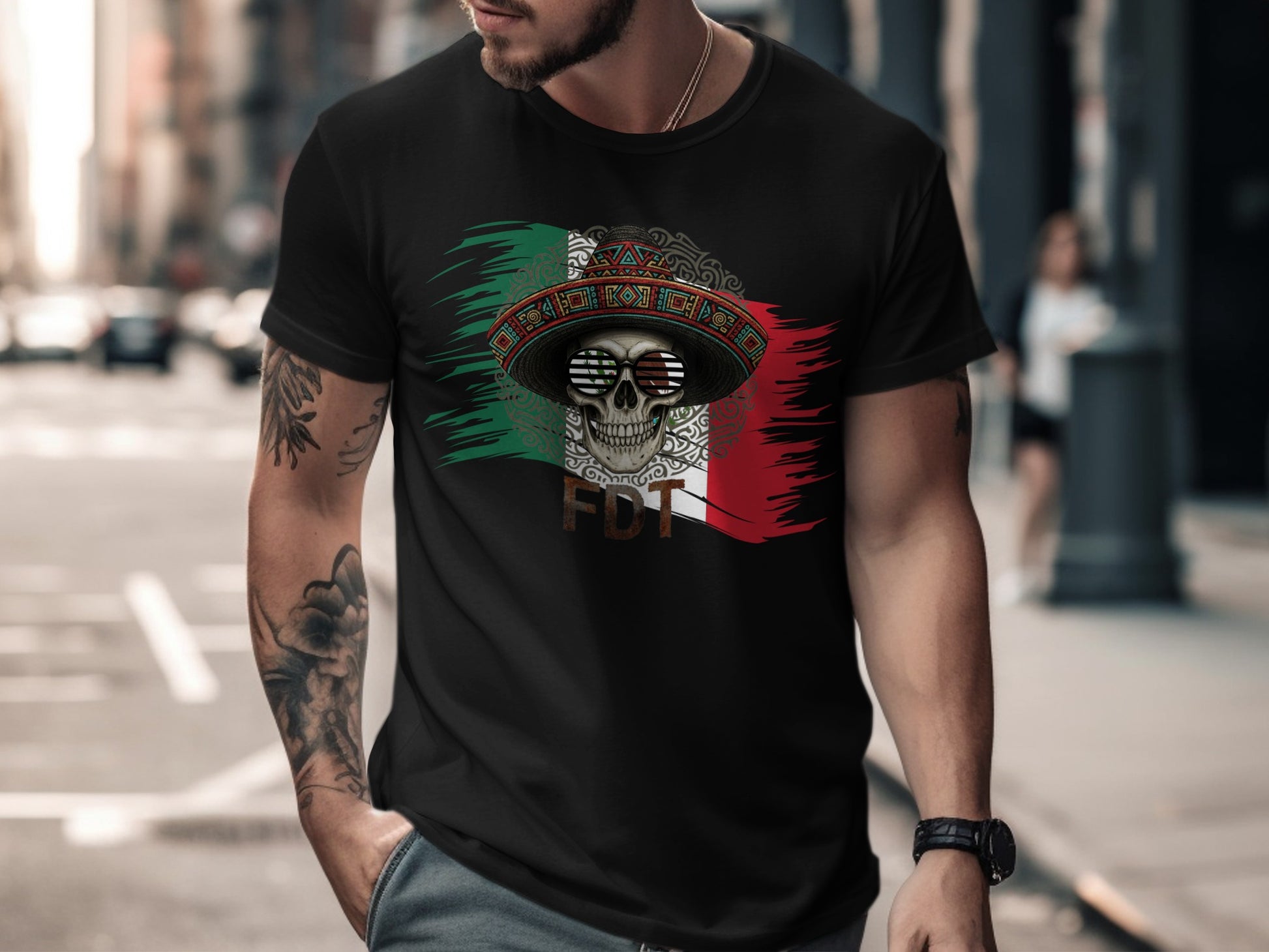 Man wearing black t-shirt with Mexican flag, sombrero, and skull graphic.