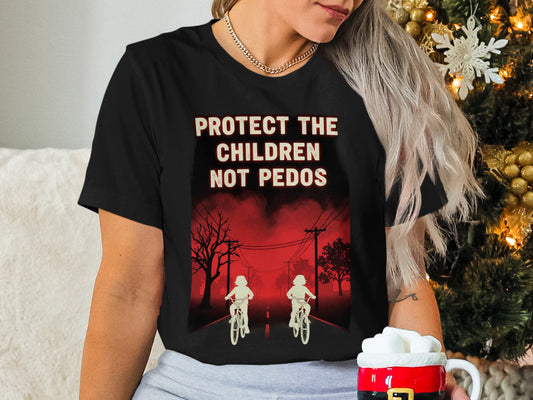 Black t-shirt with red text: "PROTECT THE CHILDREN NOT PEDOS" and two figures on bikes.