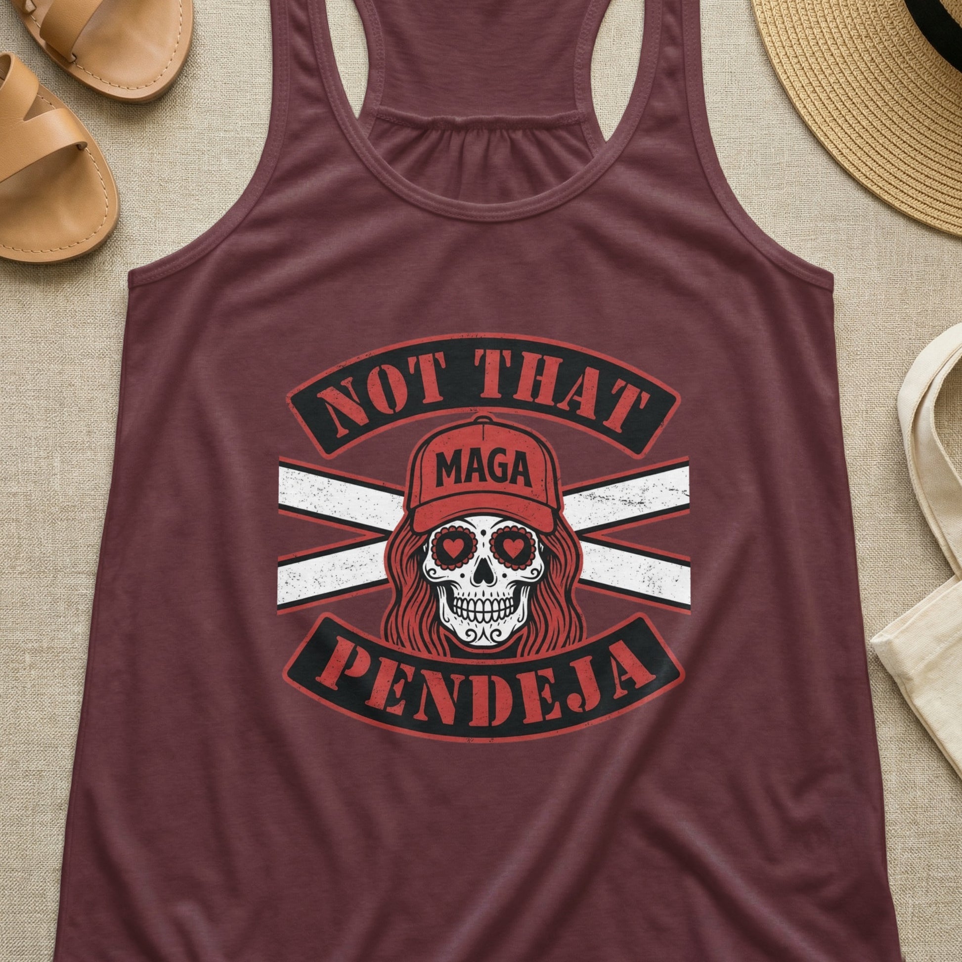 Maroon tank top with skull graphic and "Not That MAGA Pendeja" text.
