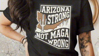 A person wearing a black t-shirt with a graphic design that says "ARIZONA STRONG NOT MAGA WRONG".