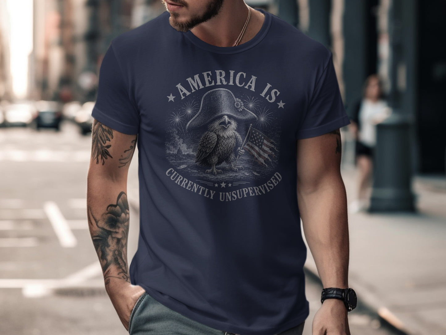 Navy t-shirt with eagle, flag, and "AMERICA IS CURRENTLY UNSUPERVISED" text.