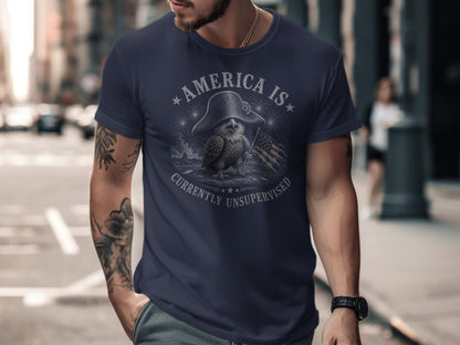 Navy t-shirt with eagle, flag, and "AMERICA IS CURRENTLY UNSUPERVISED" text.