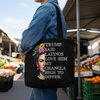 Black tote bag with Frida Kahlo graphic and "Trump said Latinos love him my chancla begs to differ" text.