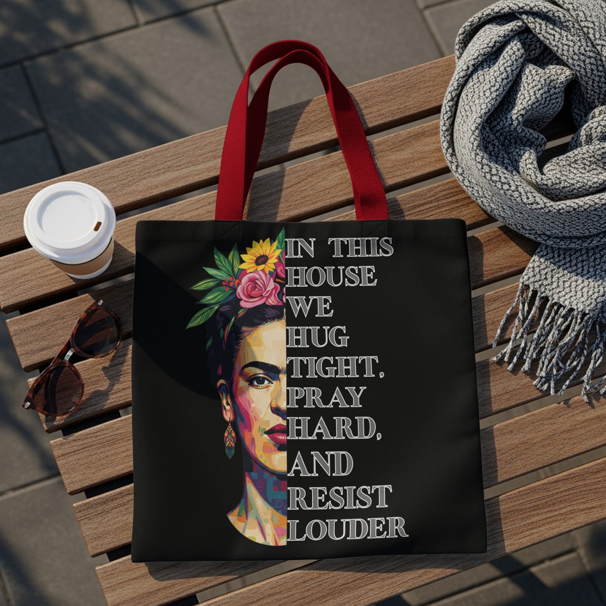 Tote bag featuring Frida Kahlo portrait and quote "In this house we hug, pray, hard, and resist louder".