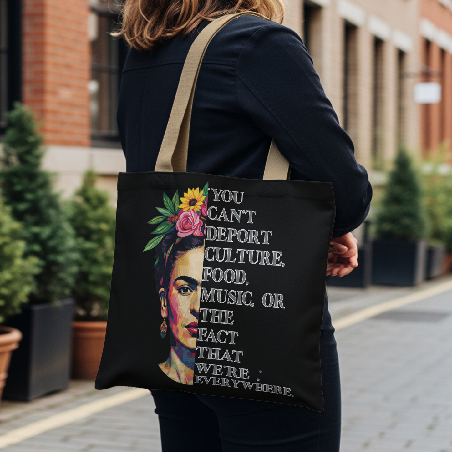 Black tote bag with Frida Kahlo portrait and quote about culture.