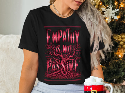 Black t-shirt with red "Empathy is not passive" text and tree root design.