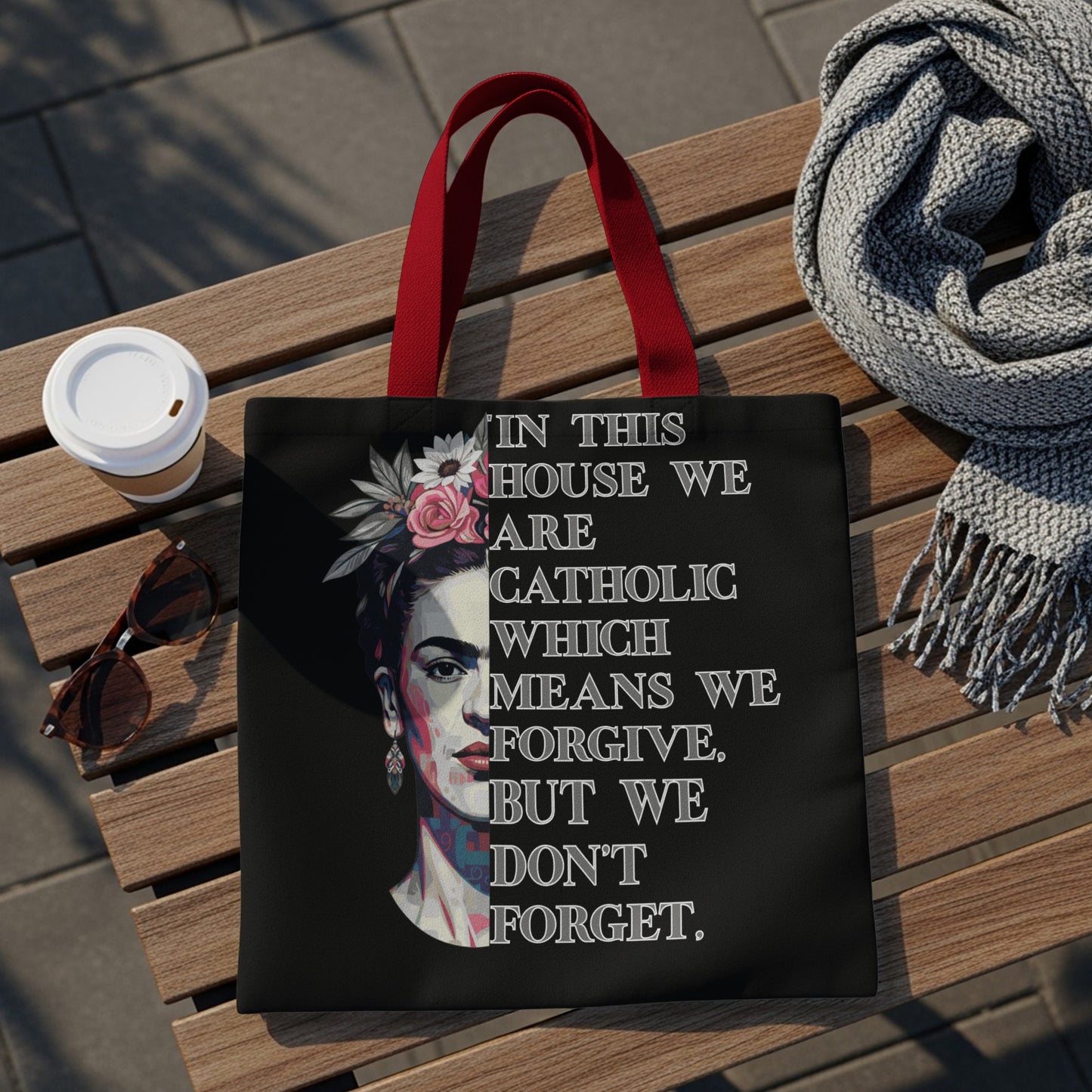 Black tote bag with Frida Kahlo portrait and quote about forgiveness.