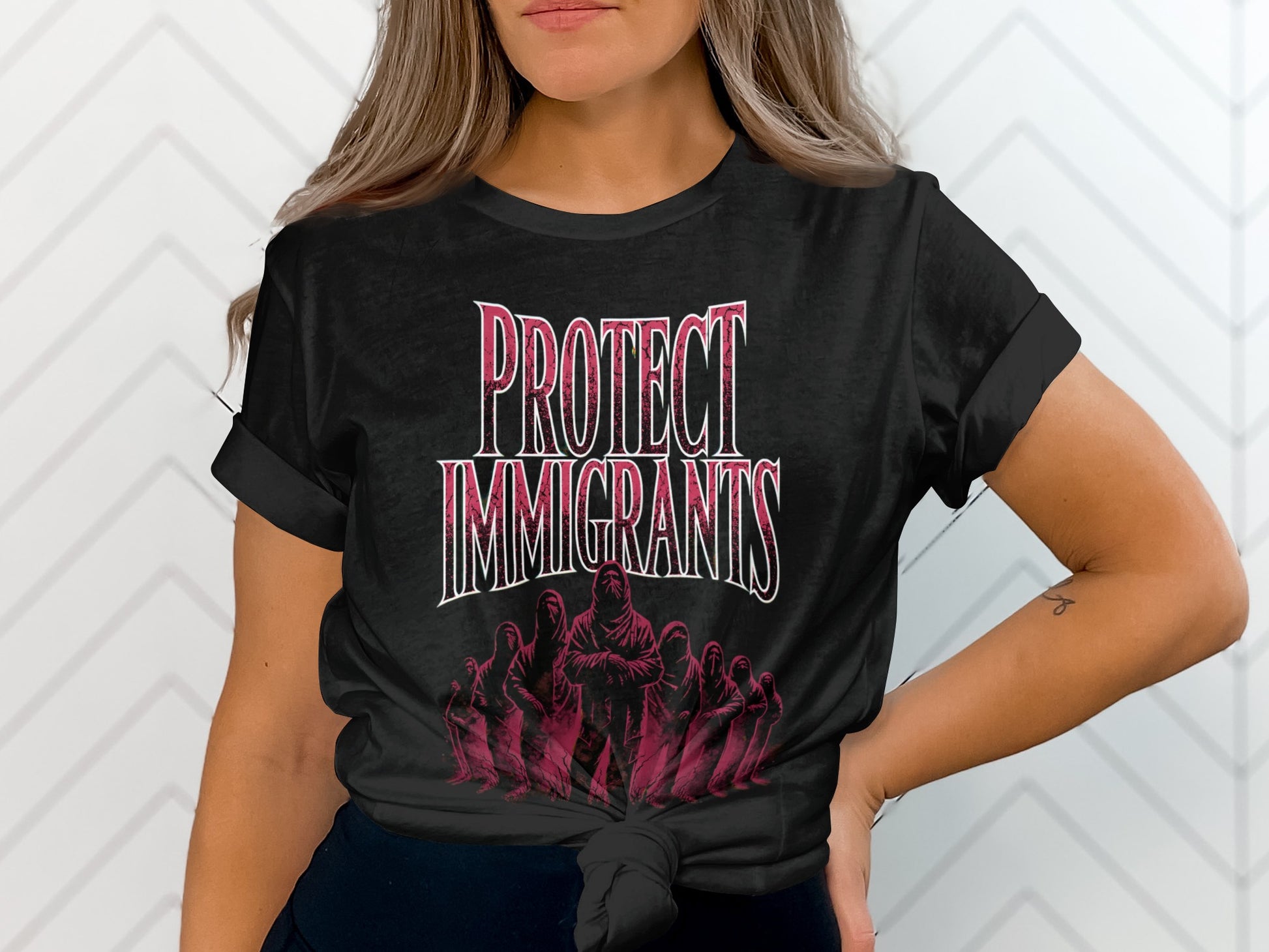 Black t-shirt with "Protect Immigrants" in pink text and a group of figures.