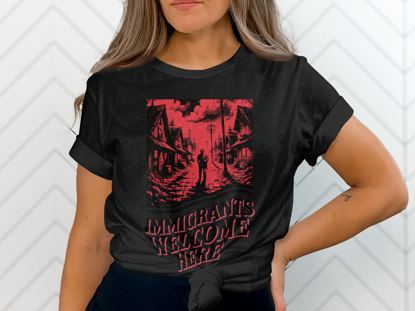 Black t-shirt with "IMMIGRANTS WELCOME HERE" text over a street scene.