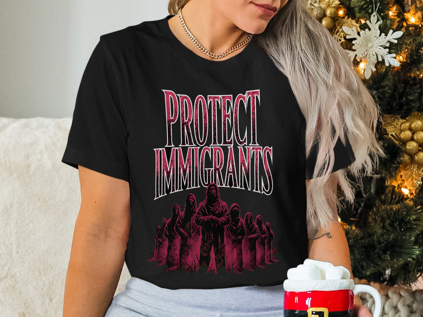 Black t-shirt with "PROTECT IMMIGRANTS" text and stylized figures.