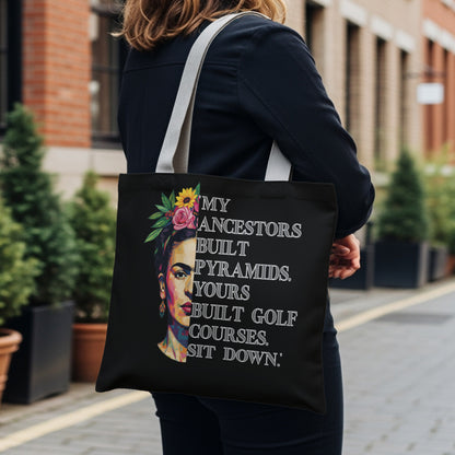 Black tote bag with Frida Kahlo portrait and empowering quote.