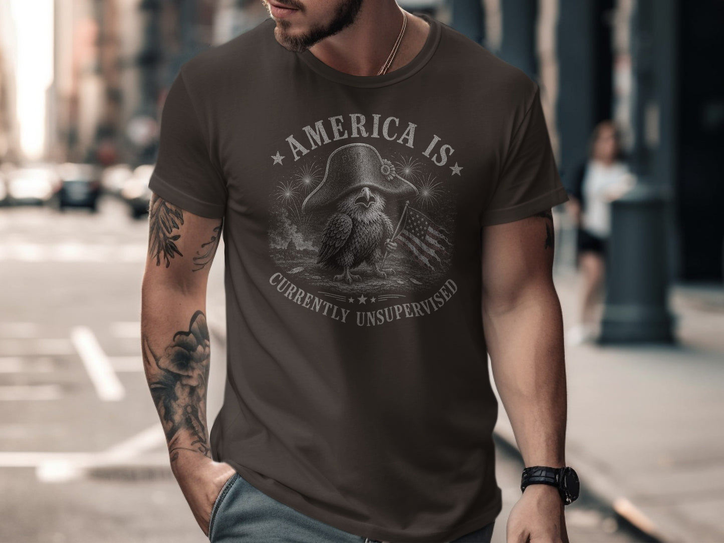 Dark t-shirt with eagle, flag, and "America Is Currently Unsupervised" text.