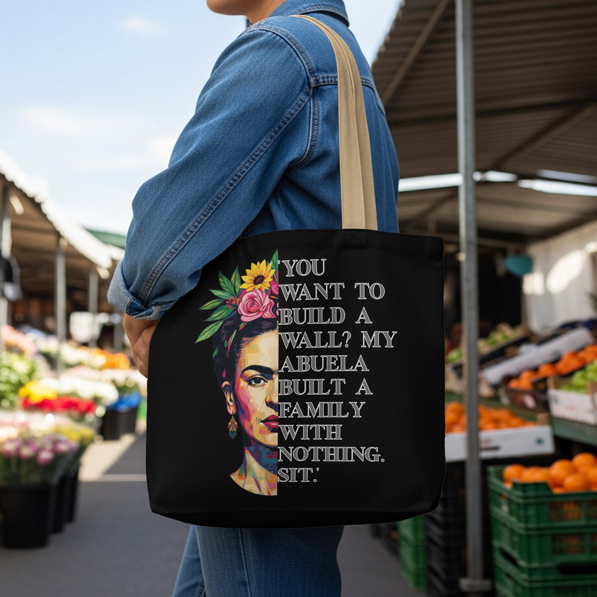Black tote bag with Frida Kahlo portrait and quote about building families.