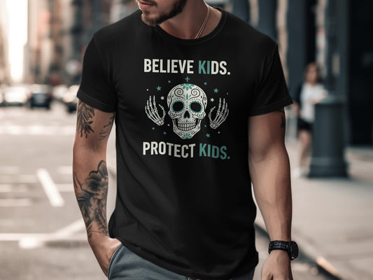 Black t-shirt with "BELIEVE KIDS. PROTECT KIDS." text and sugar skull graphic.