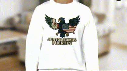 A person wearing a white sweatshirt with an embroidered eagle and the text "JUNTOS SOMOS FUERTES" printed on it.