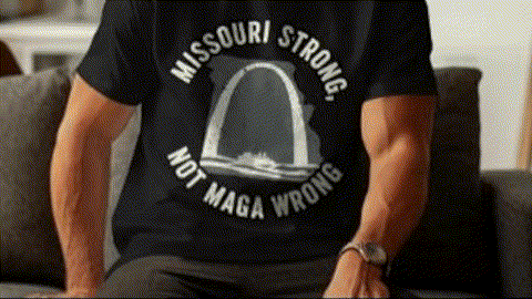 A person wearing a black t-shirt with a graphic design and text printed on it.