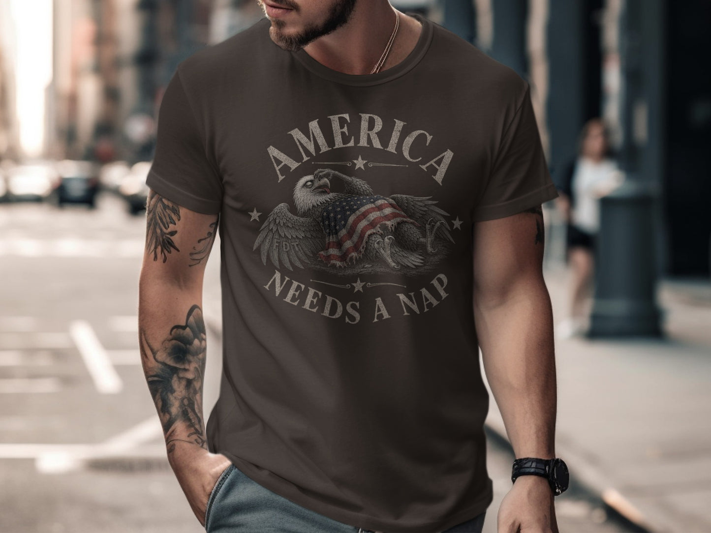 Dark t-shirt with eagle and American flag graphic, reads "America Needs a Nap".