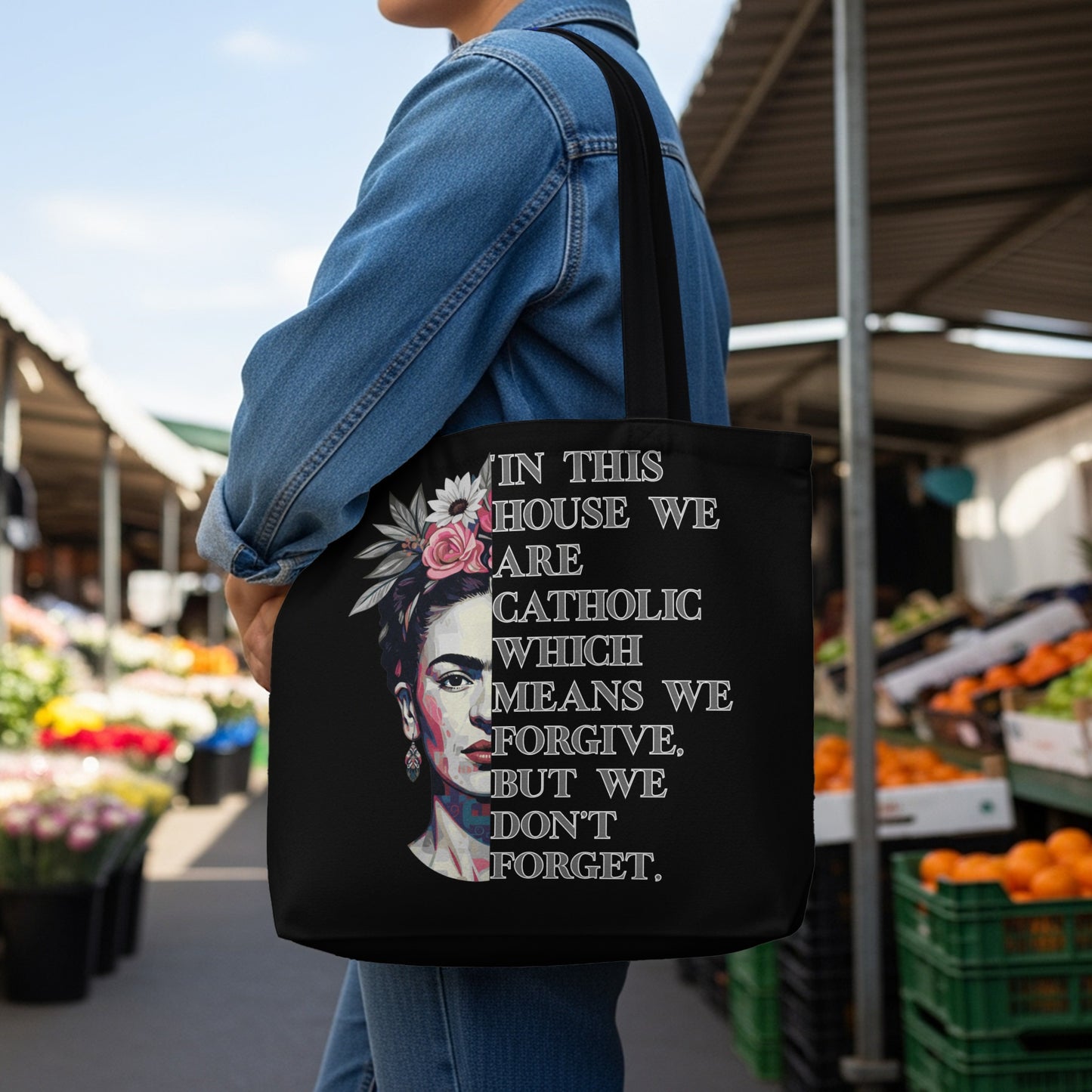 Black tote bag with Frida Kahlo portrait and quote about forgiveness.